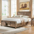 Bettgestell im Landhausstil aus warmbraunem Holz mit Stauraum und Schiebetür im Scheunentor-Stil